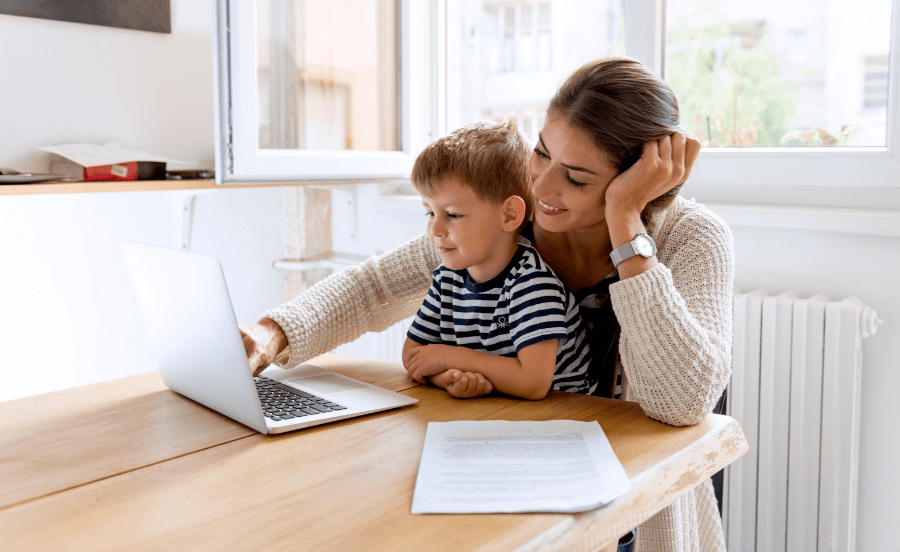 Mother and young son together lookingat a computer
