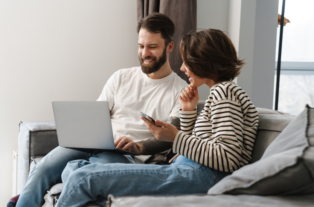 Couple looking up second mortgage options on computer